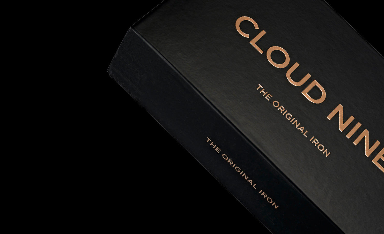 angled box of the original iron packaging with cloud nine embroidery in rose gold