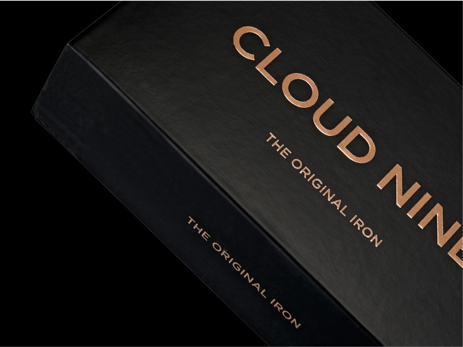 Close up of the CLOUD NINE Original Iron packaging in black, with a black background.
